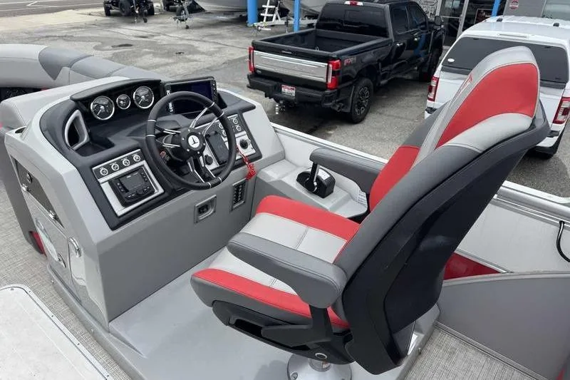 Slide: The Image of 2022 Trifecta SS 23RF boat cockpit with red and gray captain's chair and control panel. - 4