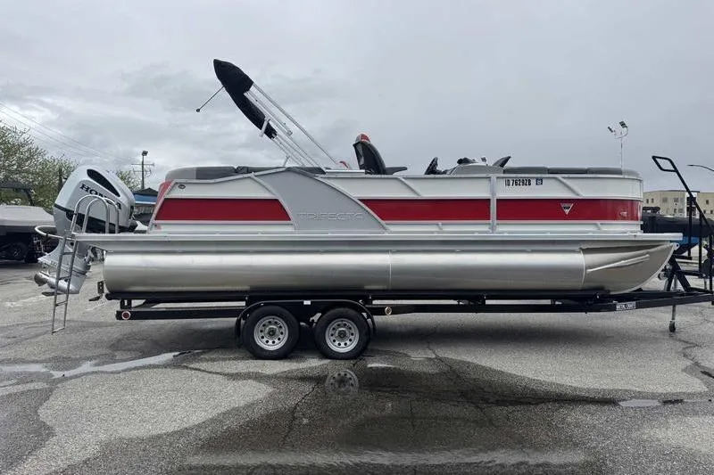 Slide: The Image of 2022 Trifecta SS 23RF pontoon boat on trailer, featuring red and silver design. - 5