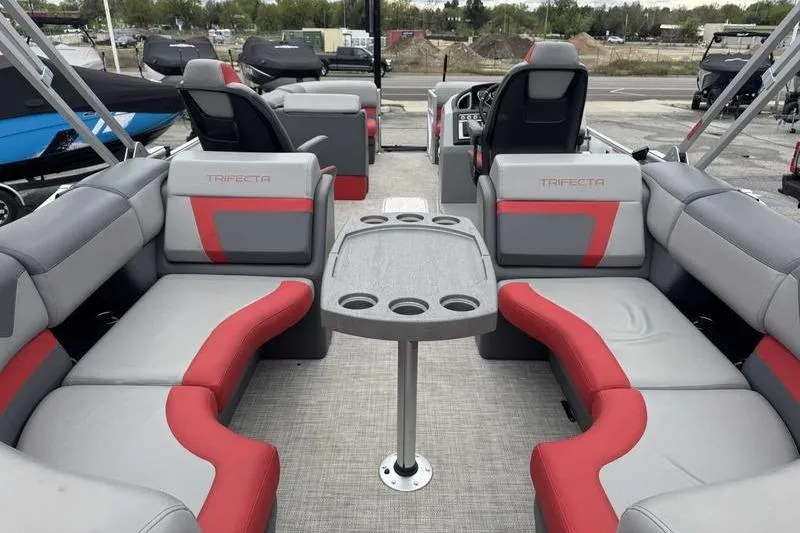 Slide: The Image of 2022 Trifecta SS 23RF pontoon boat interior with gray and red seating and table. - 7
