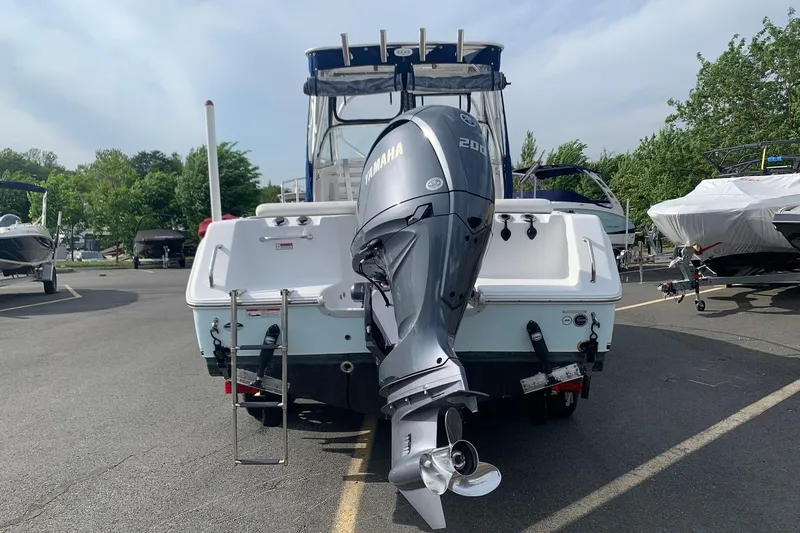 Slide: The Image of 2014 Sea Hunt Victory 225 boat with Yamaha 200 engine, parked outdoors. - 2