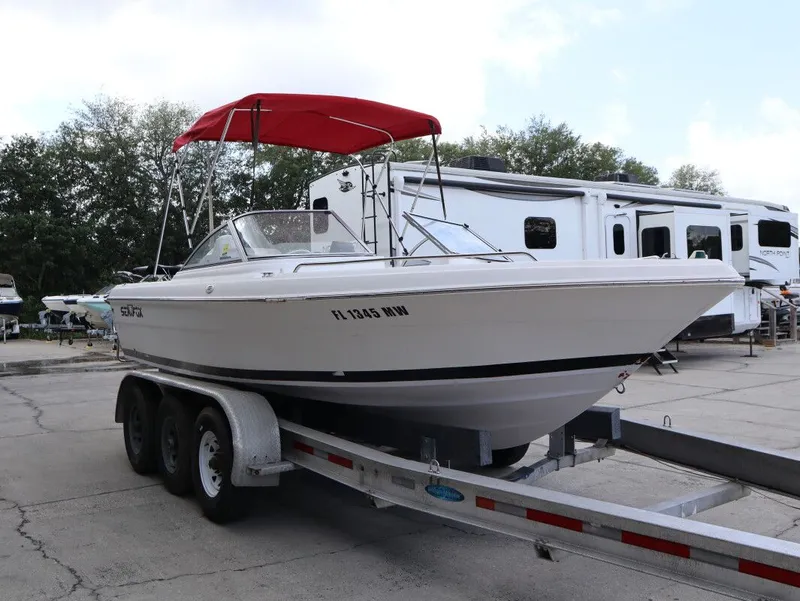 Slide: The Image of 2005 Sea Fox 206 DC boat on trailer with red canopy. - 4