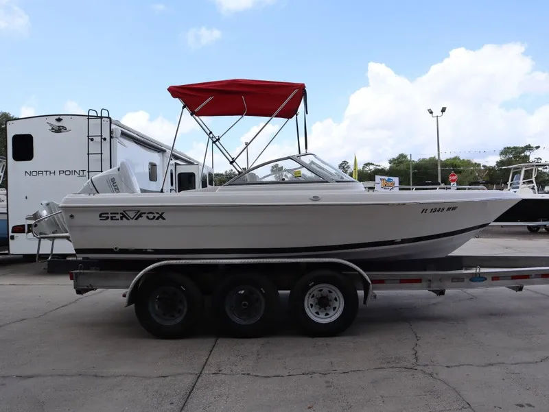 Slide: The Image of 2005 Sea Fox 206 DC boat on trailer with red canopy. - 5