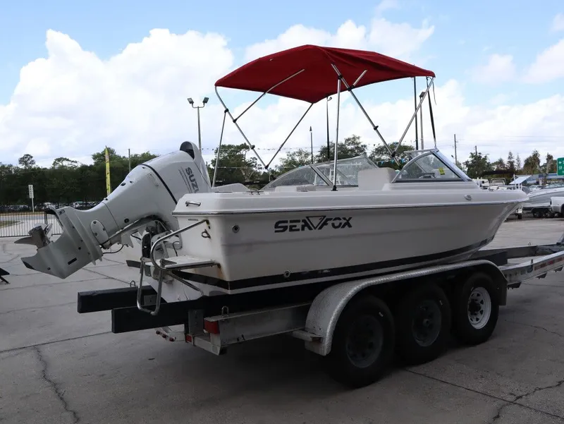 Slide: The Image of 2005 Sea Fox 206 DC boat with red canopy on trailer. - 6