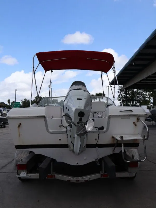 Slide: The Image of Rear view of a 2005 Sea Fox 206 DC boat with red canopy. - 7