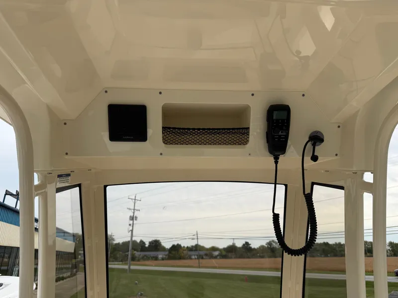 Slide: The Image of The image shows the helm of a Scout 220 XSF boat with electronics and a storage compartment. - 12