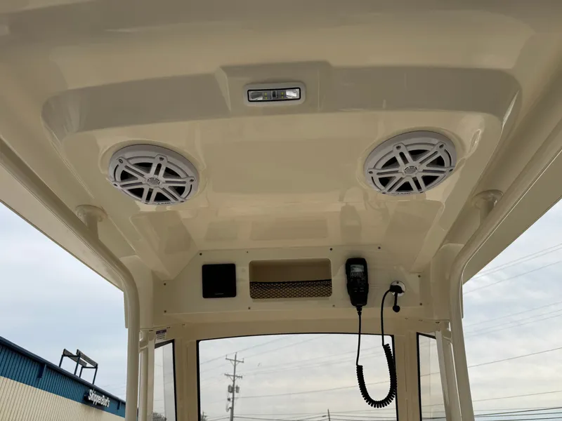 Slide: The Image of The image shows the roof of a Scout 220 XSF boat with speakers and a radio. - 13