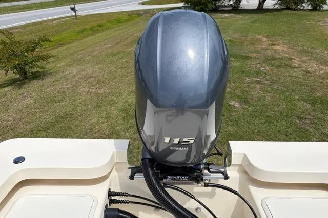 Slide: The Image of 2026 Jones Brothers Bateau 20 with Yamaha 115 outboard motor, parked on grass. - 2