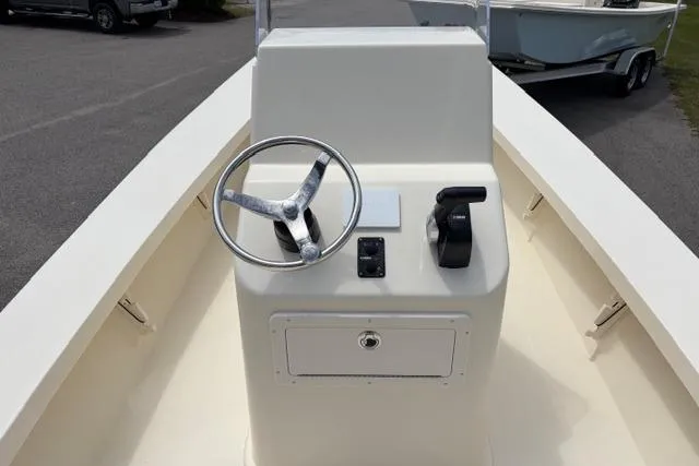 Slide: The Image of 2026 Jones Brothers Bateau 20 boat console with steering wheel and controls. - 6