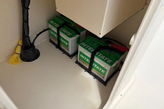 Slide: The Image of Two Interstate batteries secured in a compartment of a 2026 Jones Brothers Bateau 20 boat. - 8