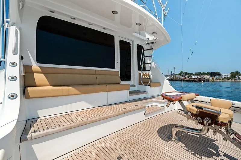 Slide: The Image of Luxury deck of 2006 Hatteras 68 Convertible yacht with seating and fishing chair. - 16