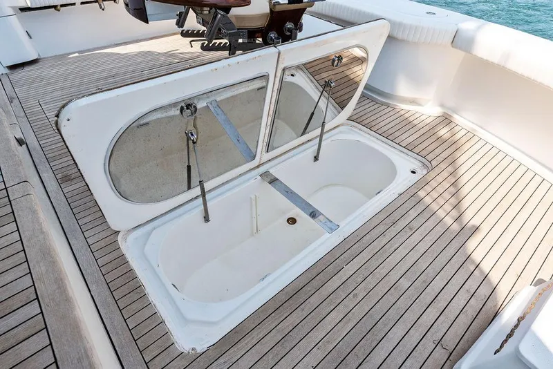 Slide: The Image of Open hatch on 2006 Hatteras 68 Convertible yacht deck, revealing storage compartment. - 20