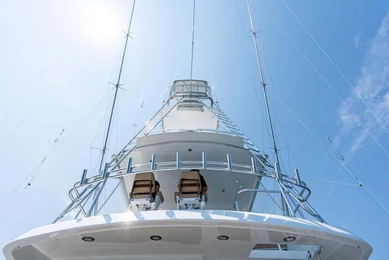 Slide: The Image of 2006 Hatteras 68 Convertible yacht, viewed from below against a clear blue sky. - 21