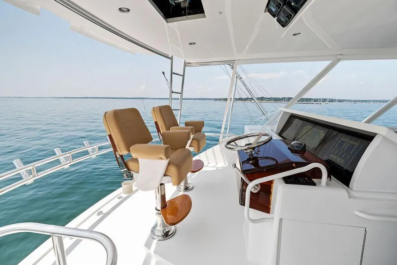 Slide: The Image of Helm of 2006 Hatteras 68 Convertible yacht with ocean view and captain's chairs. - 22