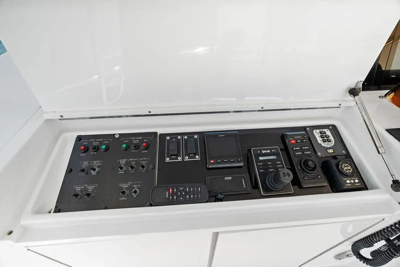 Slide: The Image of Control panel of a 2006 Hatteras 68 Convertible yacht with various navigation instruments. - 26