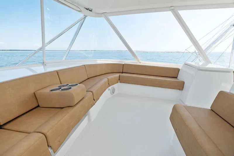 Slide: The Image of Luxurious seating area on a 2006 Hatteras 68 Convertible yacht with ocean view. - 30