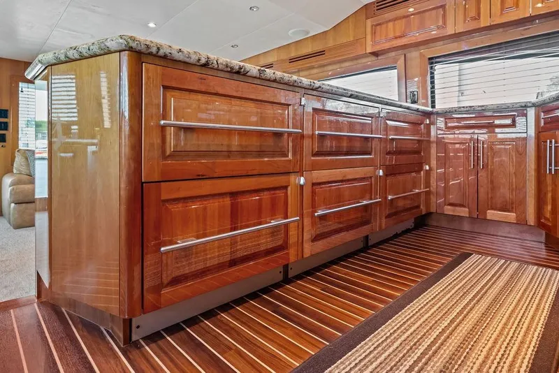 Slide: The Image of Luxurious wooden cabinetry and granite countertops in 2006 Hatteras 68 Convertible yacht interior. - 40