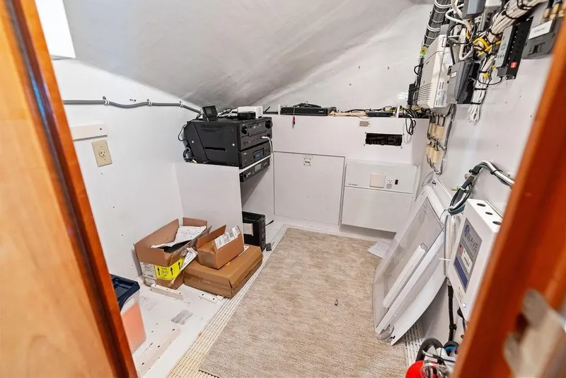 Slide: The Image of Electrical room inside a 2006 Hatteras 68 Convertible yacht, featuring wiring and equipment. - 42