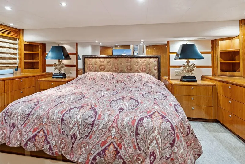 Slide: The Image of Luxurious bedroom interior of 2006 Hatteras 68 Convertible yacht with elegant bedding and wood cabinetry. - 44