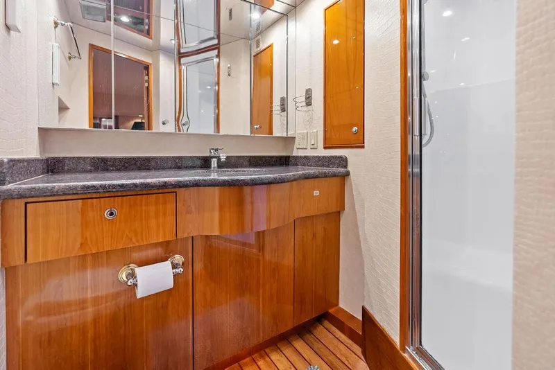 Slide: The Image of Luxurious bathroom interior of 2006 Hatteras 68 Convertible yacht with wooden cabinetry. - 49