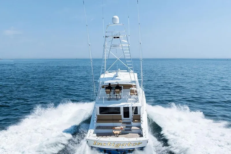 Slide: The Image of 2006 Hatteras 68 Convertible yacht cruising on open sea, rear view. - 5