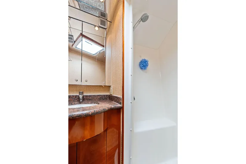 Slide: The Image of Luxurious bathroom in 2006 Hatteras 68 Convertible yacht with granite countertop and shower. - 57