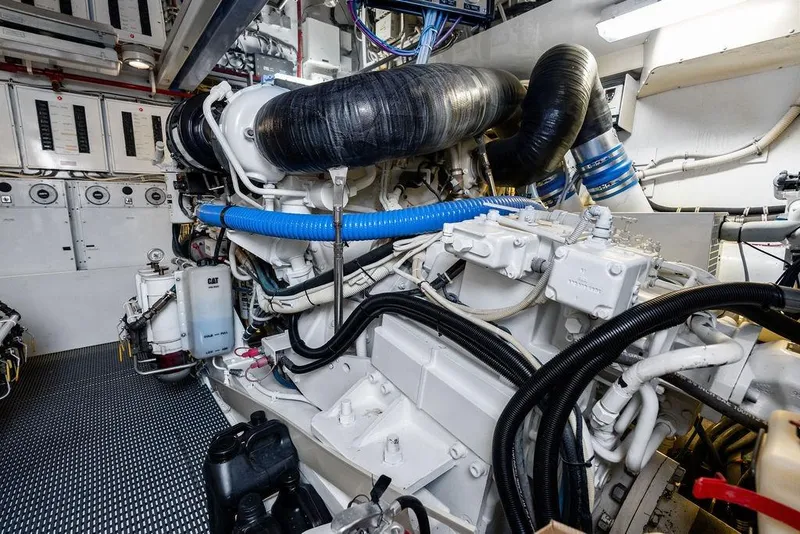 Slide: The Image of Engine room of 2006 Hatteras 68 Convertible yacht, showcasing complex machinery and wiring. - 62