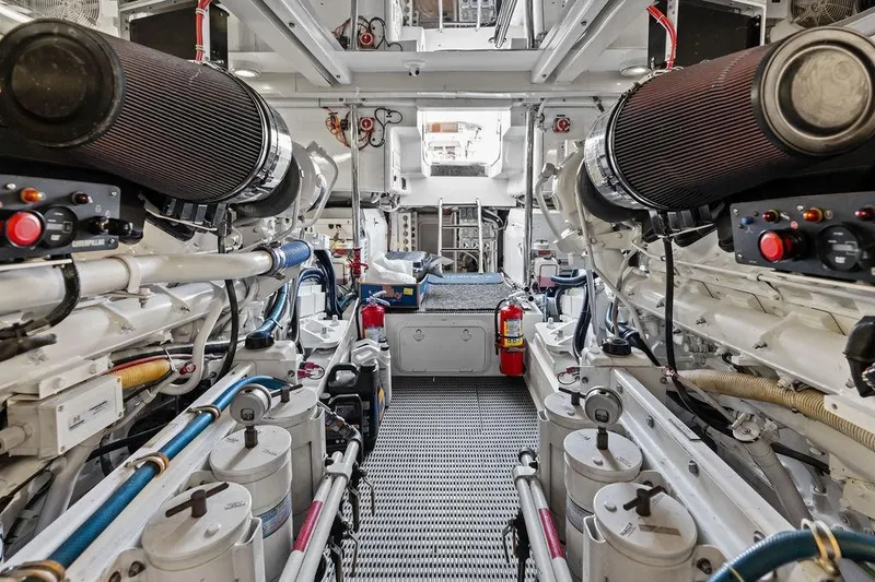 Slide: The Image of Engine room of 2006 Hatteras 68 Convertible yacht, showcasing machinery and equipment. - 64