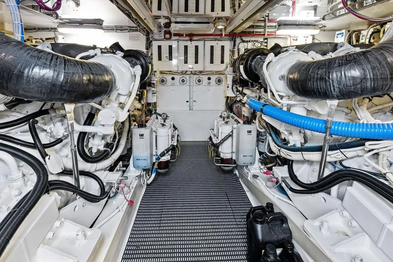 Slide: The Image of Engine room of 2006 Hatteras 68 Convertible yacht, showcasing dual engines and mechanical systems. - 65