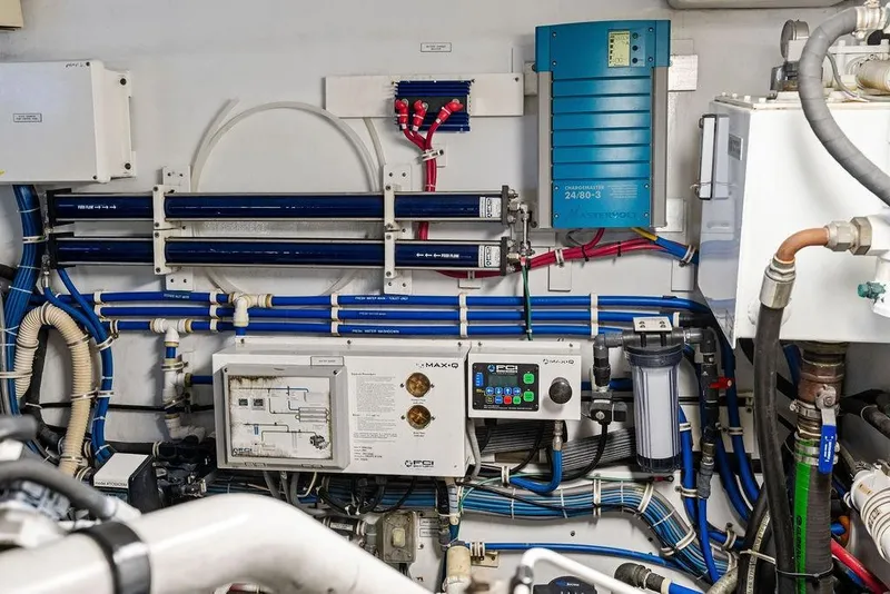 Slide: The Image of Engine room of 2006 Hatteras 68 Convertible yacht, showcasing complex wiring and control systems. - 69