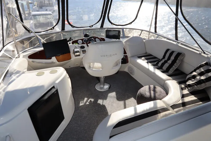 Slide: The Image of Interior of 2005 Meridian 459 Motoryacht with helm and seating area. - 17