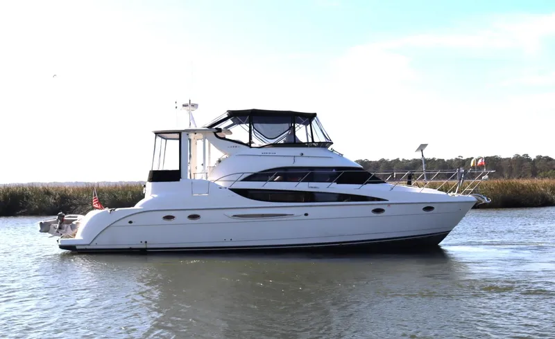 Slide: The Image of 2005 Meridian 459 Motoryacht cruising on a calm river. - 2