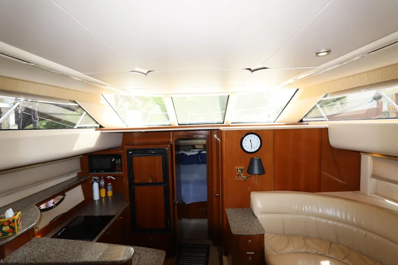 Slide: The Image of Interior of 2005 Meridian 459 Motoryacht with seating, kitchenette, and natural light. - 38