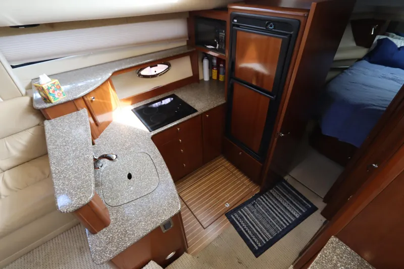 Slide: The Image of Luxurious 2005 Meridian 459 Motoryacht interior kitchen with modern amenities and elegant design. - 40