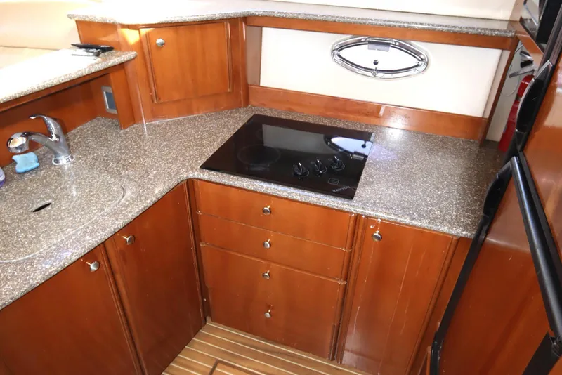 Slide: The Image of 2005 Meridian 459 Motoryacht kitchen with wood cabinets and modern appliances. - 42