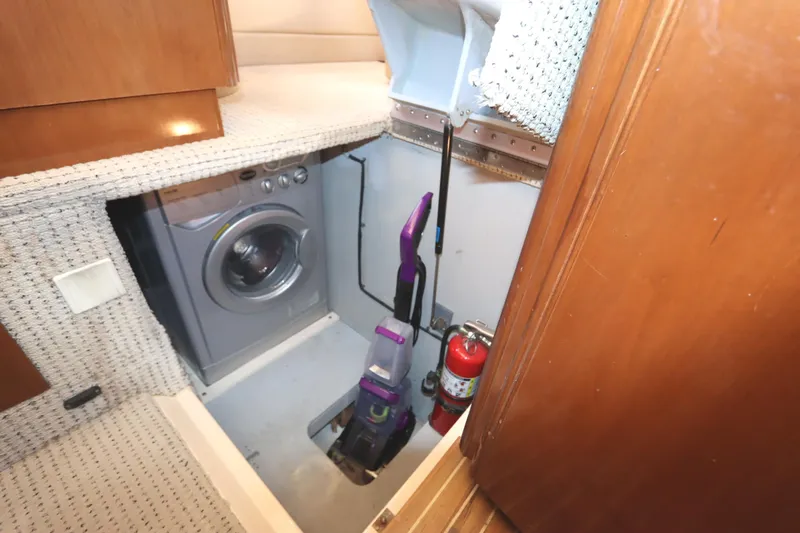 Slide: The Image of Interior of 2005 Meridian 459 Motoryacht with washer and vacuum cleaner. - 49