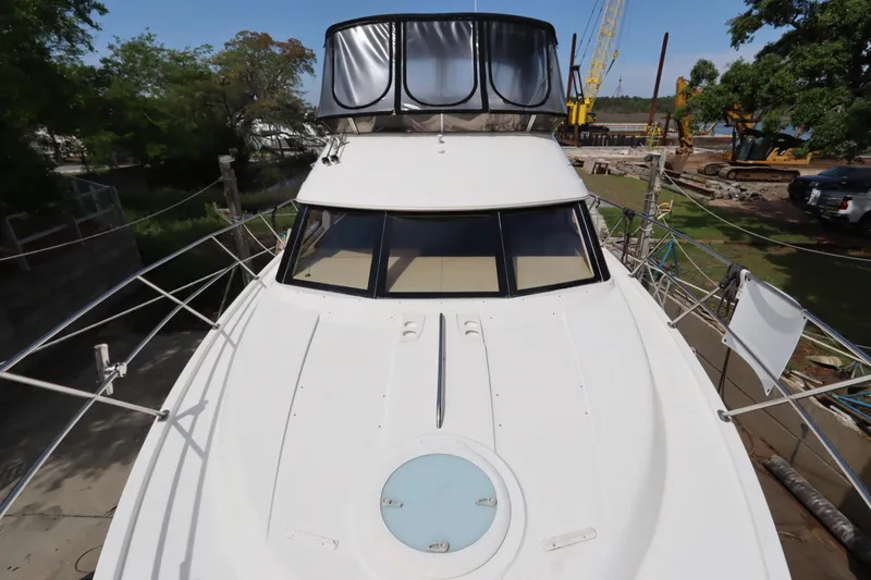 Slide: The Image of 2005 Meridian 459 Motoryacht docked, showcasing sleek design and spacious deck. - 5