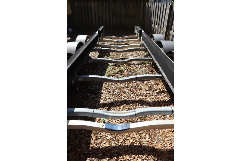Slide: The Image of Boat trailer frame for 2005 Meridian 459 Motoryacht, surrounded by leaves. - 75