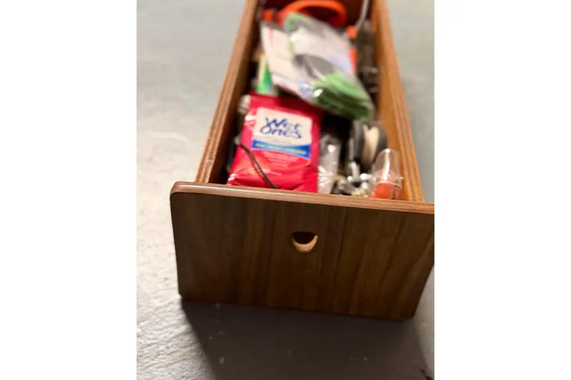 Slide: The Image of Wooden drawer filled with miscellaneous items, including wipes and tools, PAC model 23, 1976. - 19