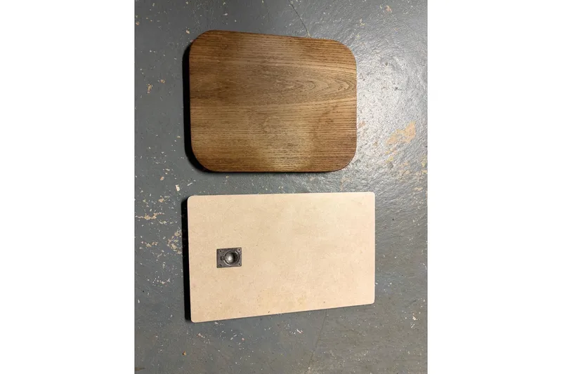 Slide: The Image of Two rectangular panels, one wooden and one beige, on a textured floor. - 20
