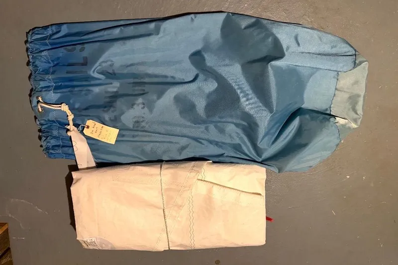 Slide: The Image of Blue and white PAC 23 bag from 1976, featuring a drawstring closure. - 4