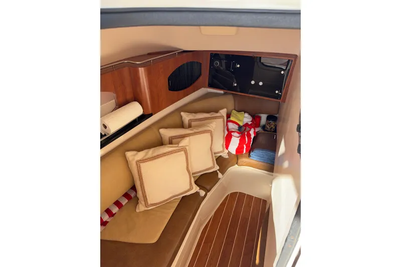 Slide: The Image of 2014 Grady-White Freedom 335 cabin interior with cushions and wooden accents. - 10