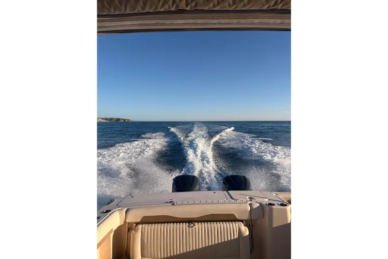 Slide: The Image of Grady-White Freedom 335 boat cruising on open sea, leaving a wake behind. - 11