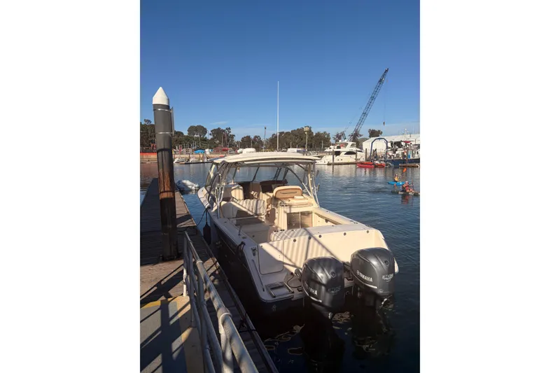 Slide: The Image of 2014 Grady-White Freedom 335 boat docked at marina with clear blue sky. - 12