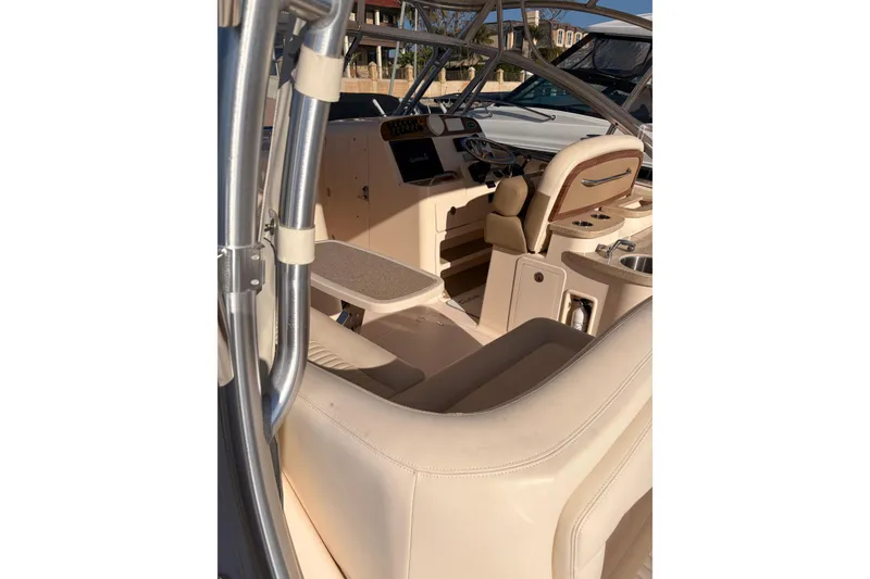 Slide: The Image of 2014 Grady-White Freedom 335 boat interior with beige seating and control panel. - 14