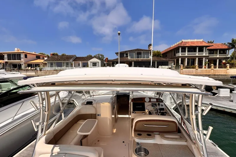 Slide: The Image of 2014 Grady-White Freedom 335 boat docked, showcasing spacious interior and luxury features. - 17