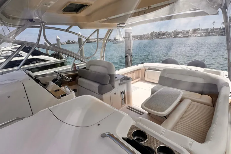 Slide: The Image of Interior view of a 2014 Grady-White Freedom 335 boat, featuring comfortable seating and scenic water backdrop. - 19