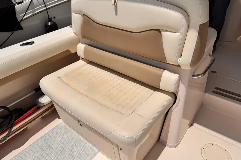 Slide: The Image of Cream and tan seating on a 2014 Grady-White Freedom 335 boat. - 24