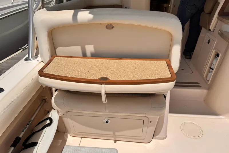 Slide: The Image of 2014 Grady-White Freedom 335 boat interior with cushioned seating and storage compartment. - 25