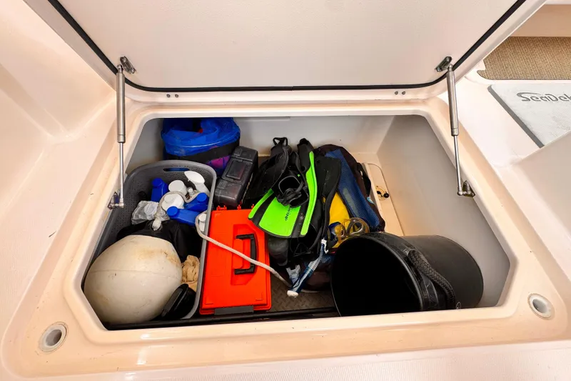 Slide: The Image of Storage compartment on a 2014 Grady-White Freedom 335 boat filled with gear and equipment. - 26