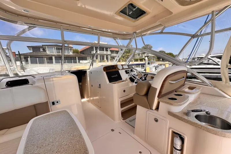 Slide: The Image of Interior of a 2014 Grady-White Freedom 335 boat, featuring helm and seating area. - 27